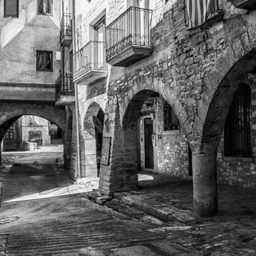 Interior of the medieval village of Guimerà, with its decorated doors, arches and windows and its stone streets.
