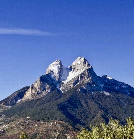 a majestic view of Pedraforca with its two snow-capped peaks
